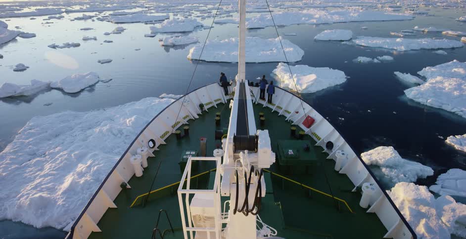 Aerial view of people on the edge of a boat sailing
