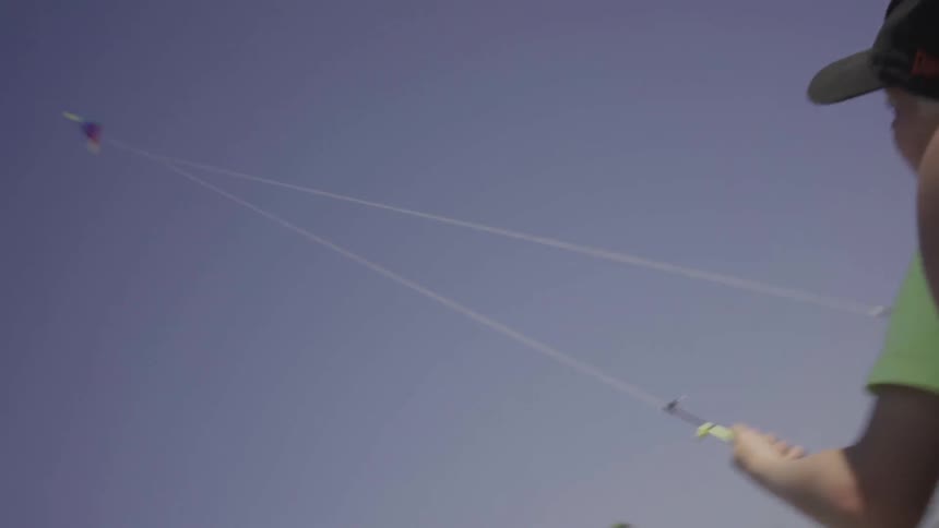A man and boy are flying a kite together