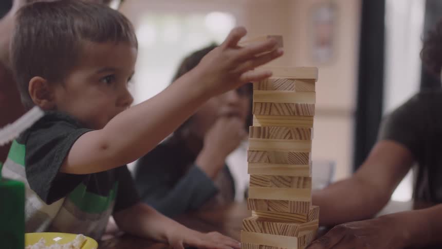 A family play a board game together