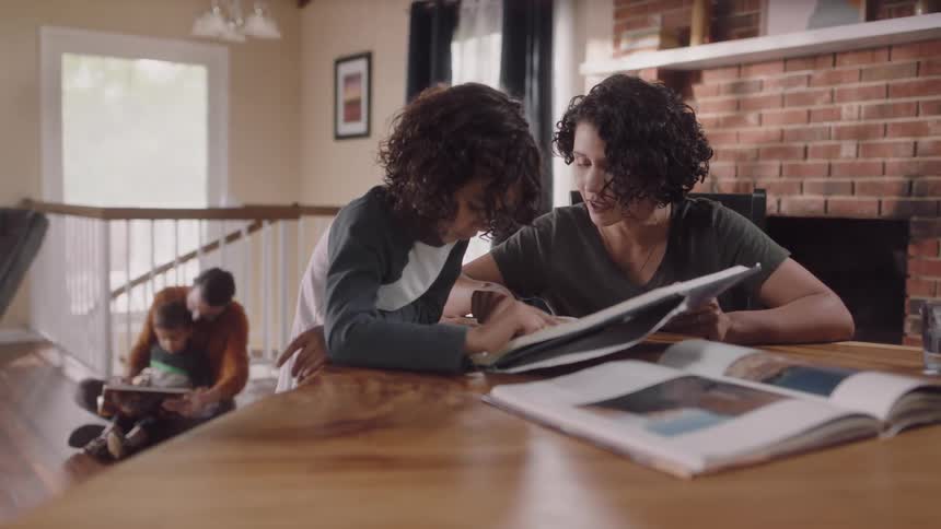 A family sitting around reading together