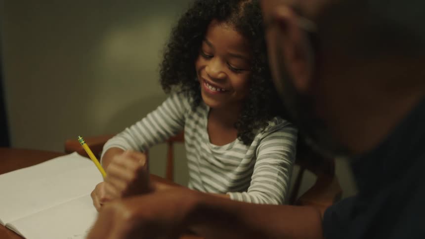 A father helping his daughter with homework