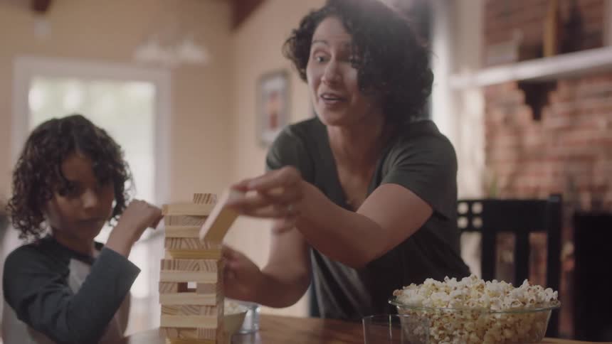 A family play a board game together