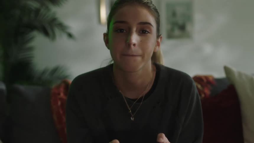 Young woman sitting on a couch at home frustrated while playing video games