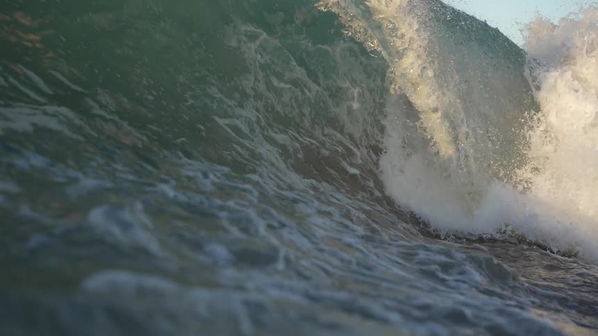 A close view of a crashing ocean wave in the daytime