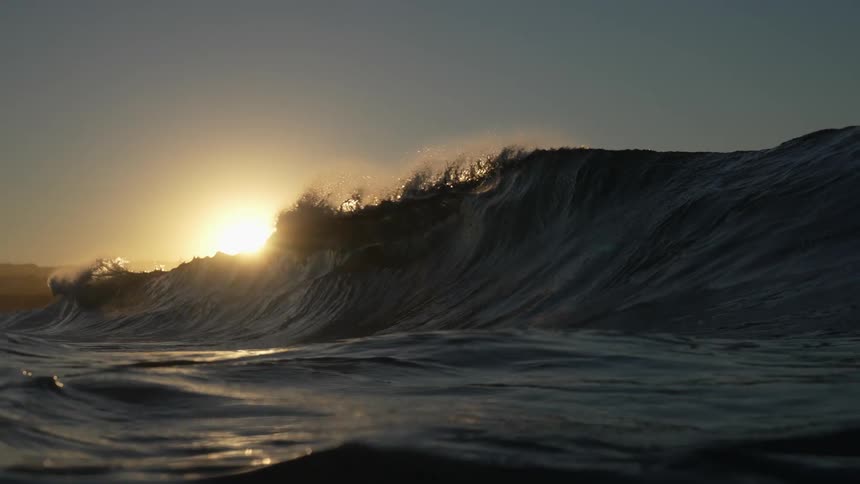 A wave rolls in and crashes over itself