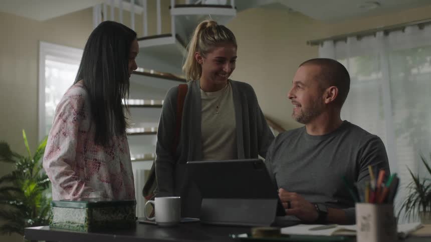 A group of people sitting inside talking and laughing