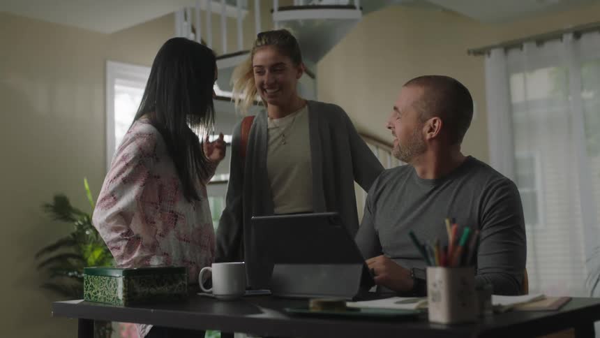 Friends greeting each other in the living room at home
