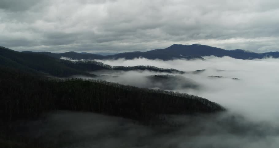 Aerial view of clouds covering the gentle slopes of a mountain range