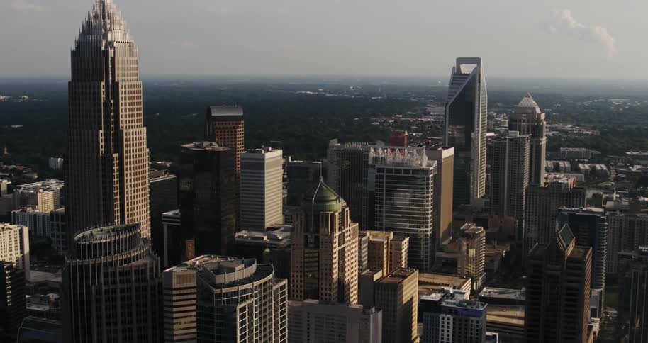 City skyscrapers stand tall above other rooftops