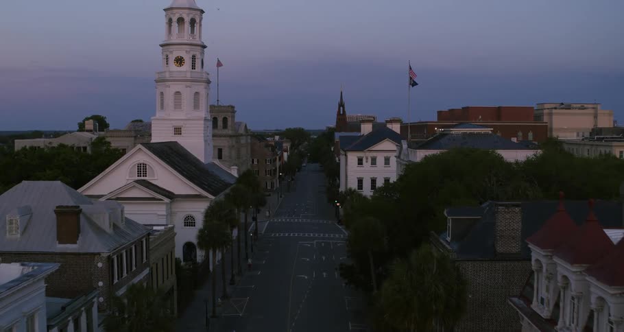 Aerial view of the streets and small buildings of a town at evening