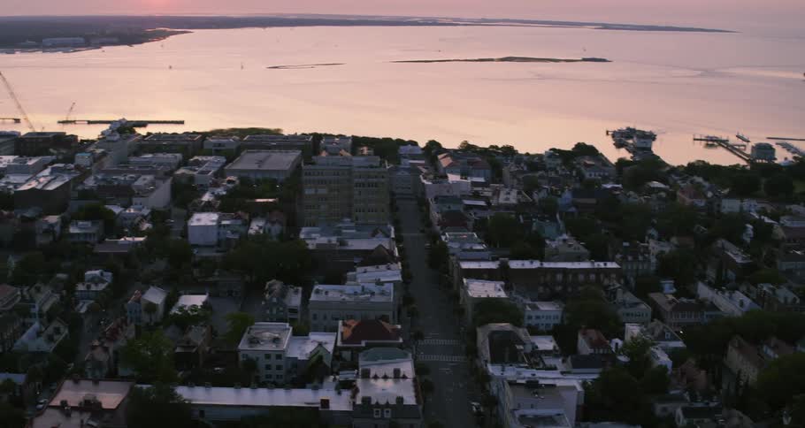 The sun is rising on the coastal city