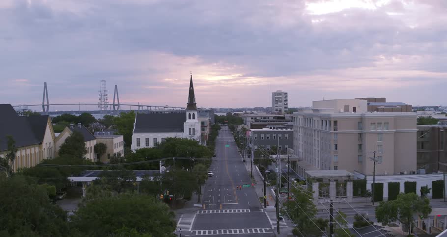 An aerial view of a city street with apartment buildings and cars