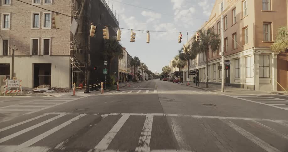 A quiet city street lined with buildings and cars