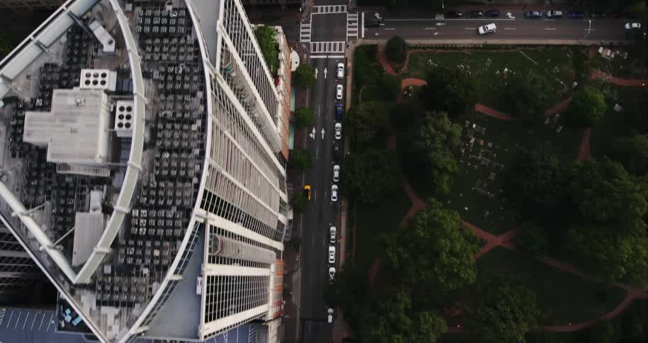 Top down aerial view of cars driving on the city streets