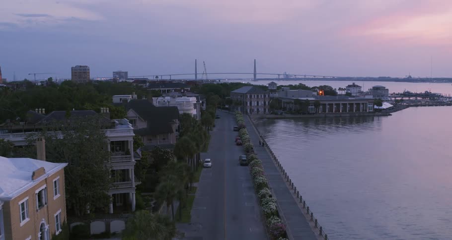 An aerial view of buildings and cars along a street on the shore