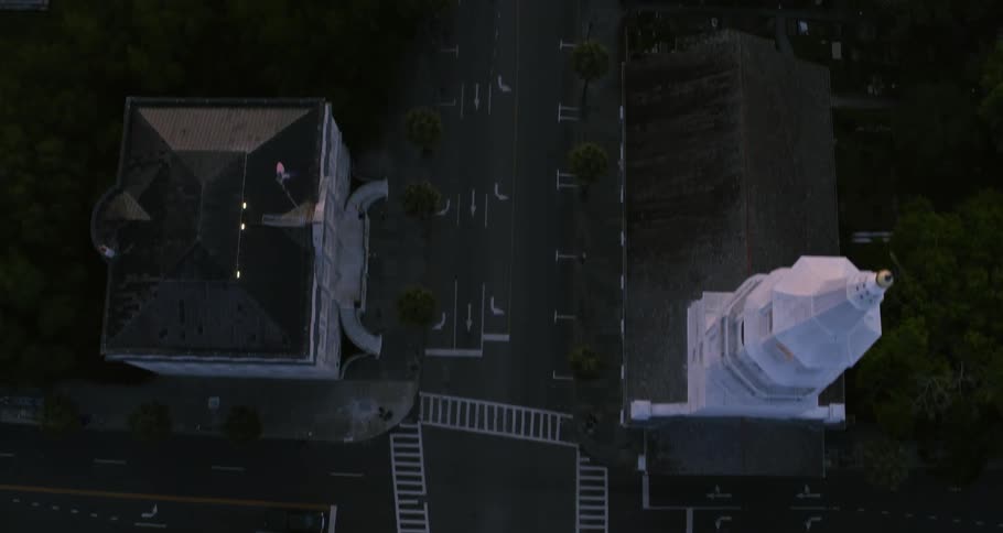 Aerial view of the empty streets and the building rooftops of a small town at evening