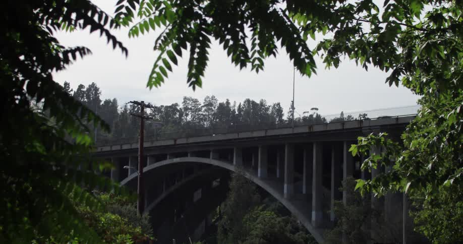 Cars are traveling over a bridge