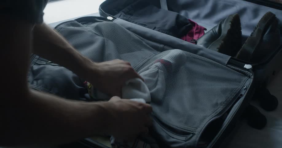 Person packing suitcase