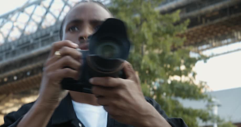 A man points his camera to take photographs