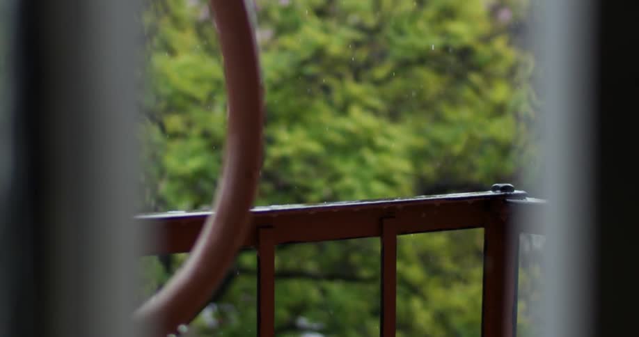 View of a fire escape with rain pouring down