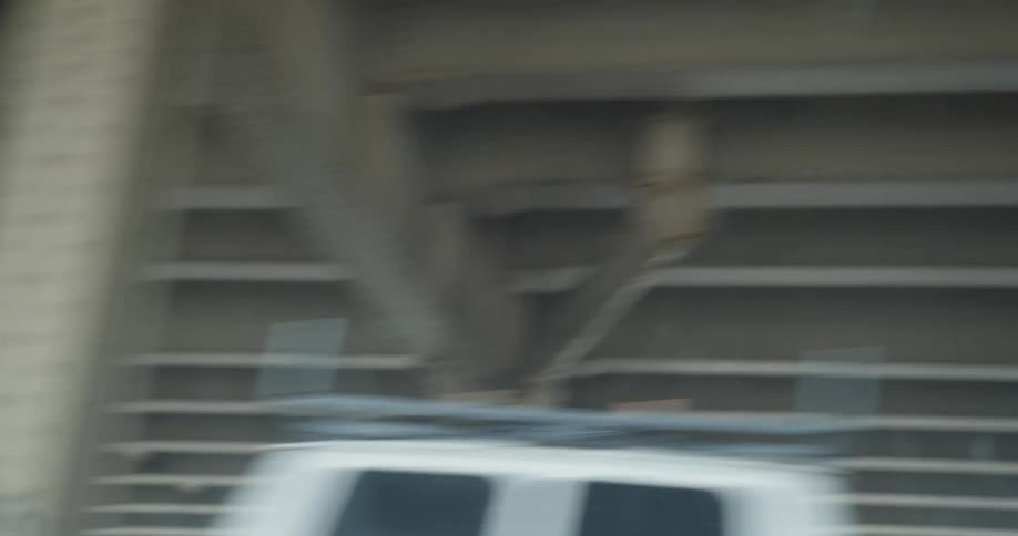 Vehicle parallels overpass as it passes other vehicles