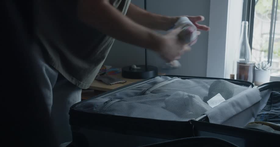A man is packing his luggage