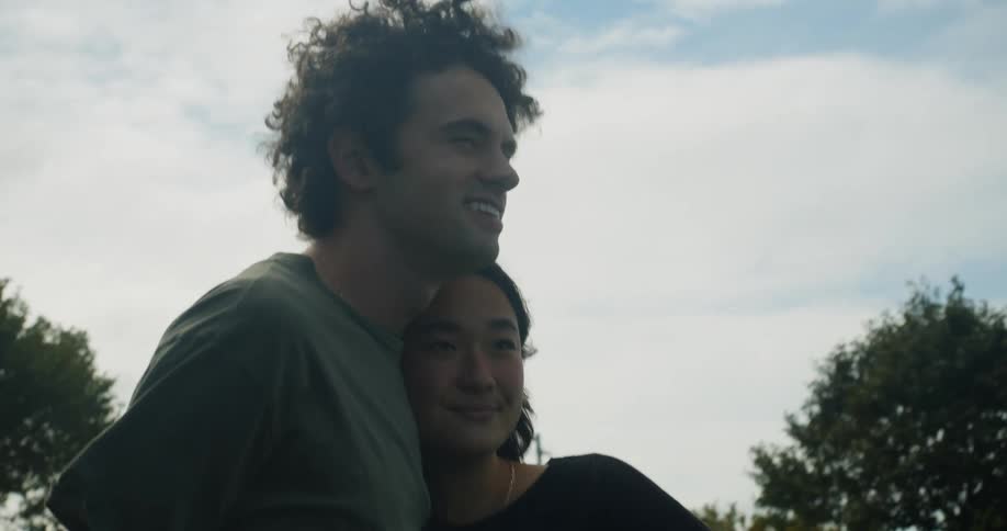A man and woman standing outdoors talking