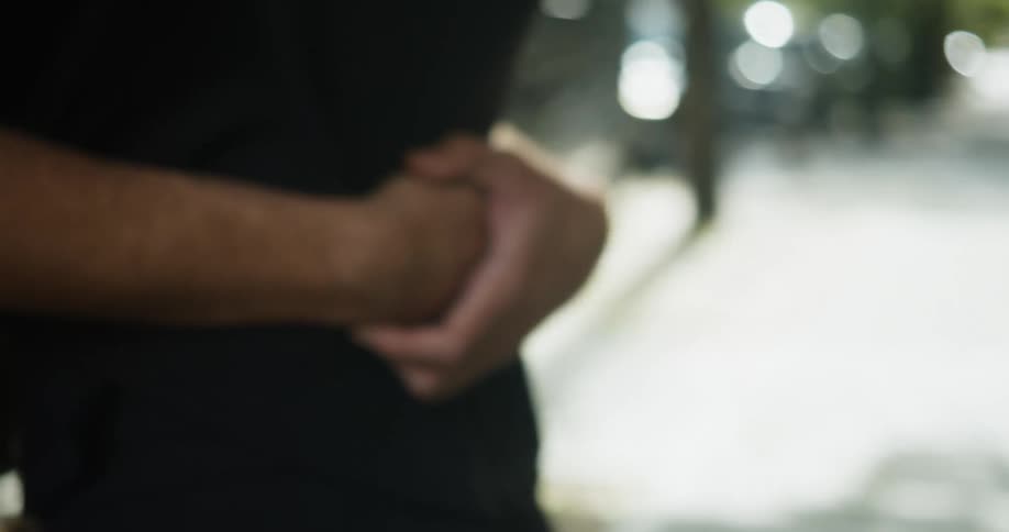 Man and woman hug standing on sidewalk near homes in neighborhood
