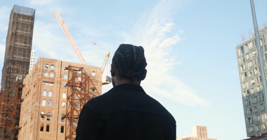 Man looks around city while consulting mobile phone