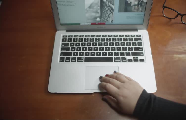 A person opening up a laptop