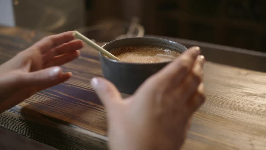 A person grabbing a bowl off of a counter