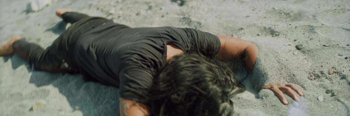 A man falls down in the sand
