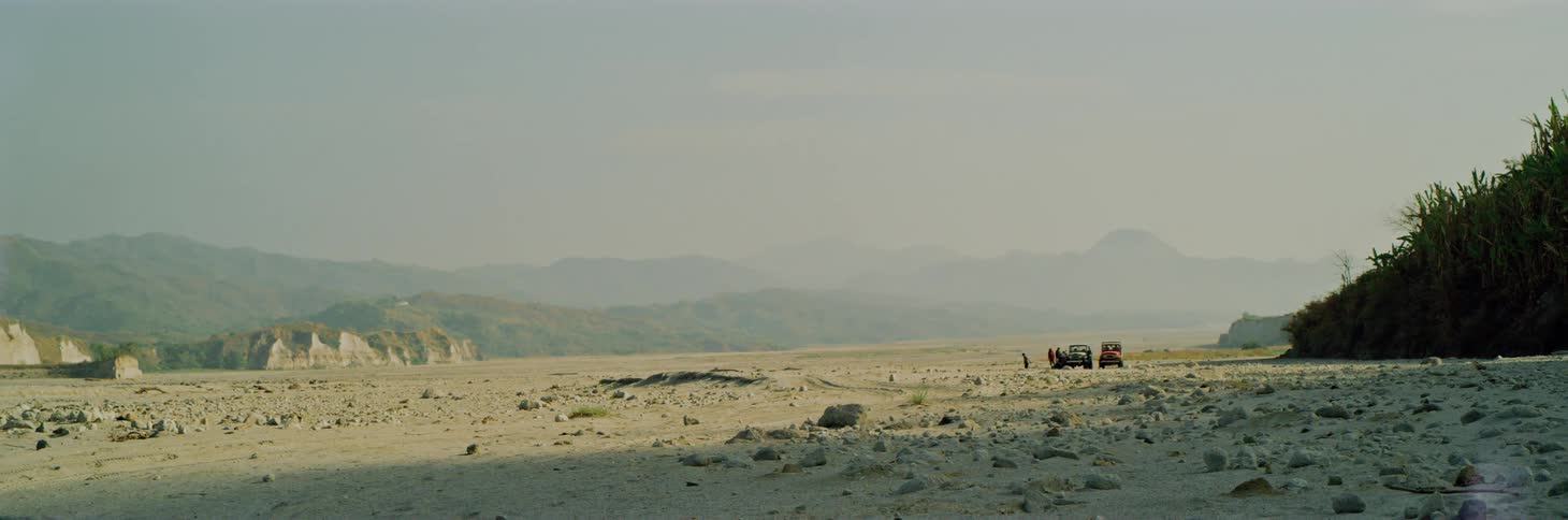The long field leads to a foggy area