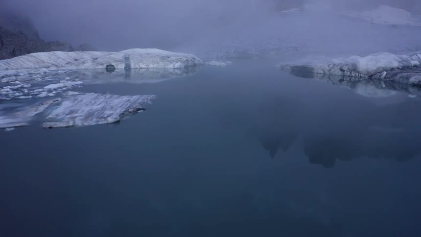 The clouds flow over the ice on the mountain
