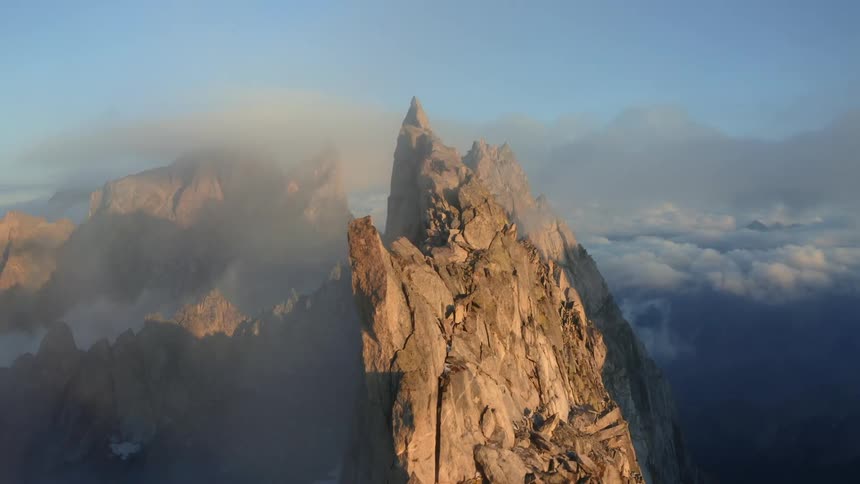 Mountain ridge with peaks high in the clouds