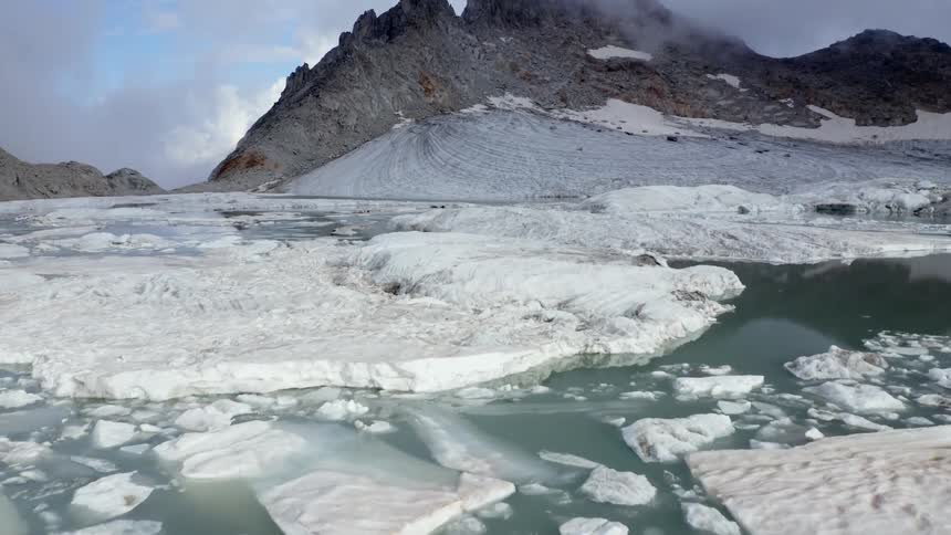 Ice lines the water on the mountain top