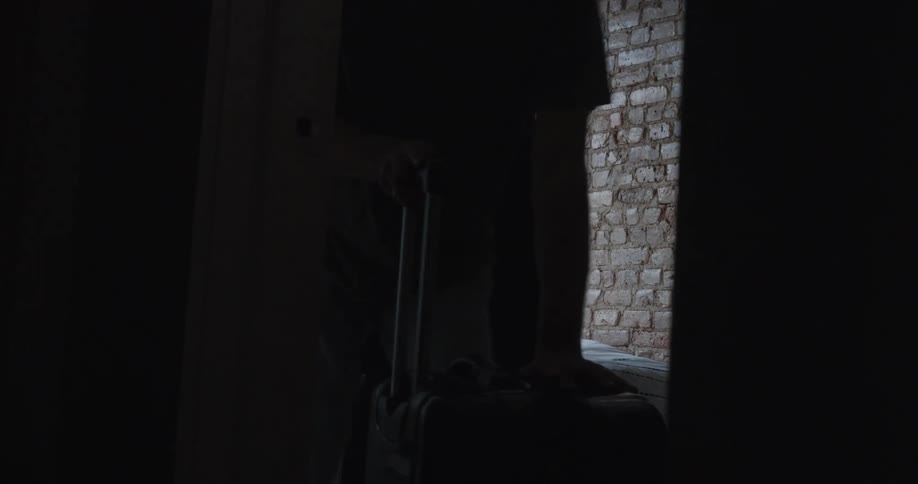 College students roll their luggage out of their dorm room