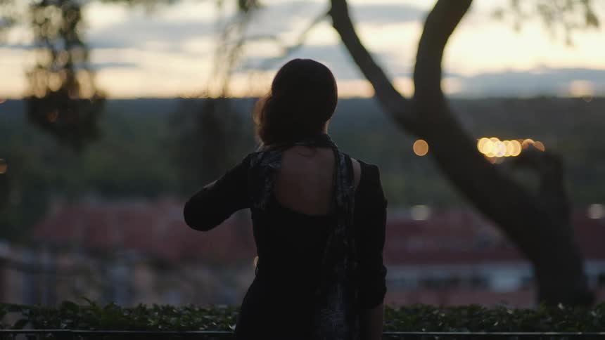 A woman and child watch the sunrise