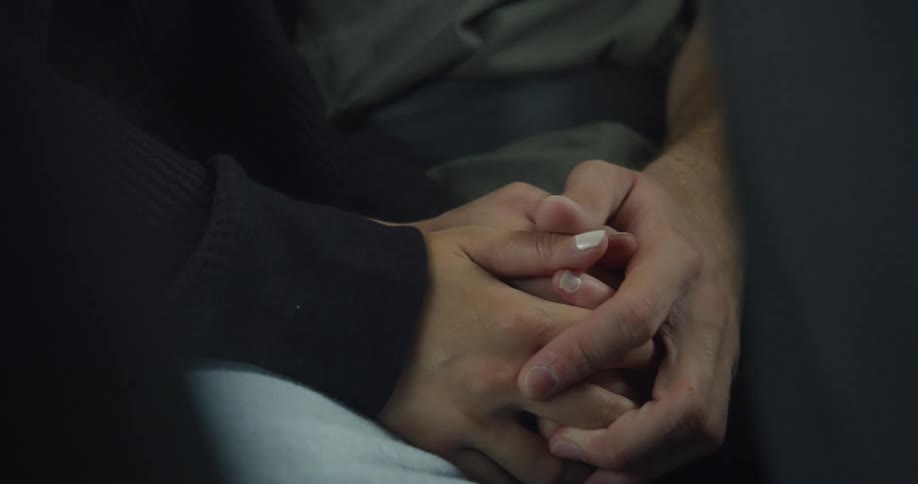 Two people holding hands