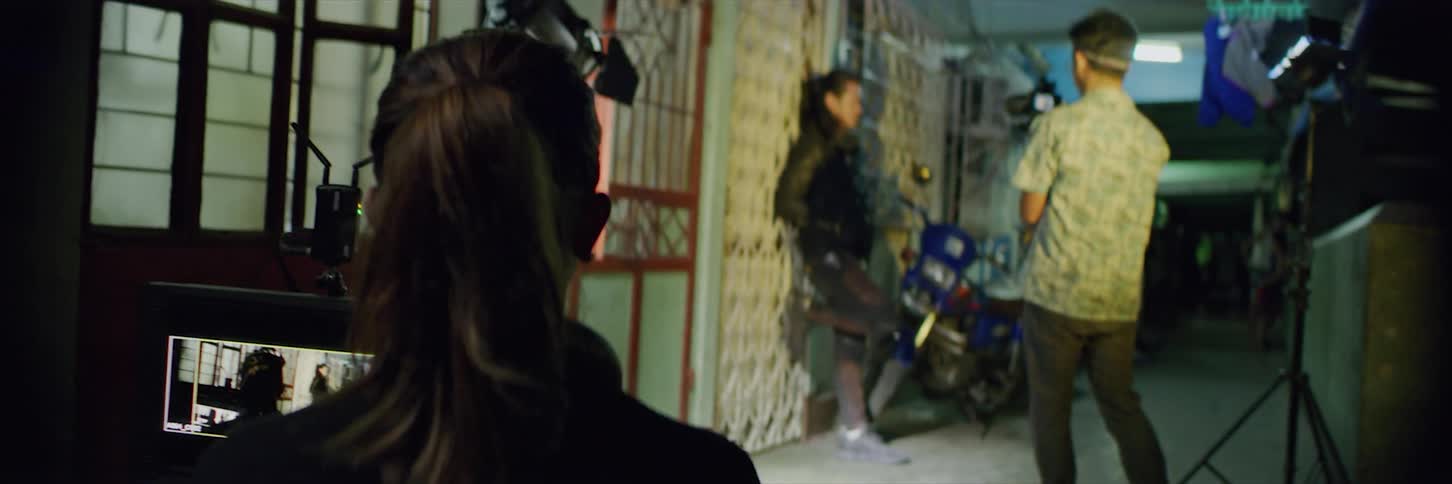 People are filming an actor on a balcony