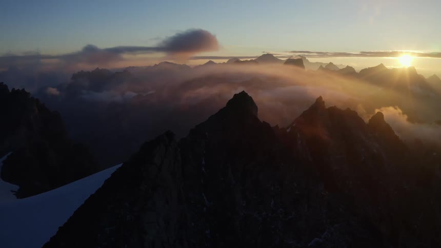 An aerial view of a mountain range as the sun sets