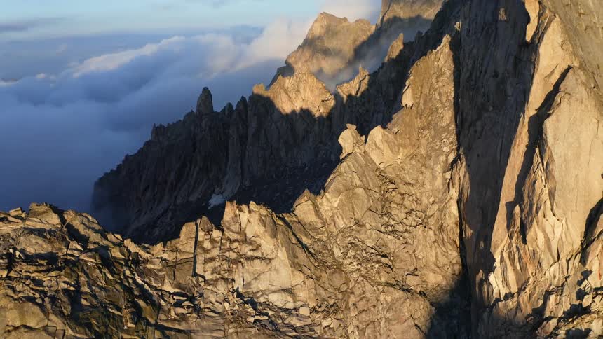 The tall mountains reach higher than the clouds