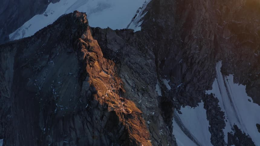 Snow settles in the valleys and slopes of a mountain range