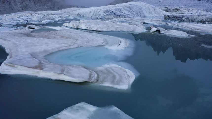 Aerial view of icebergs floating near a glacier