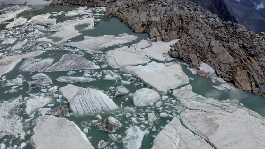 Ice floats on water that reflects clouds and fills plateau near drop off