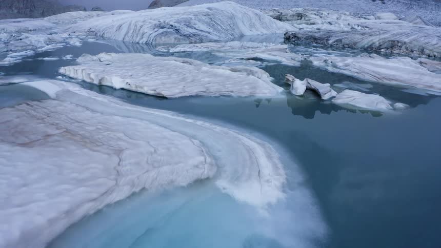 The water is full of ice and snow
