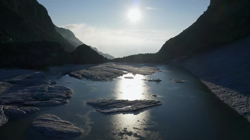 The sun is reflecting off the mountain top ice