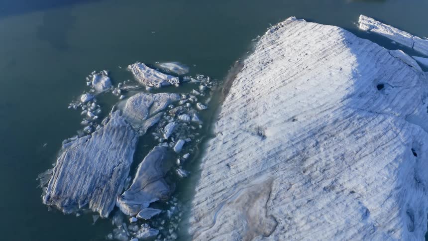 An aerial view of icebergs in the ocean