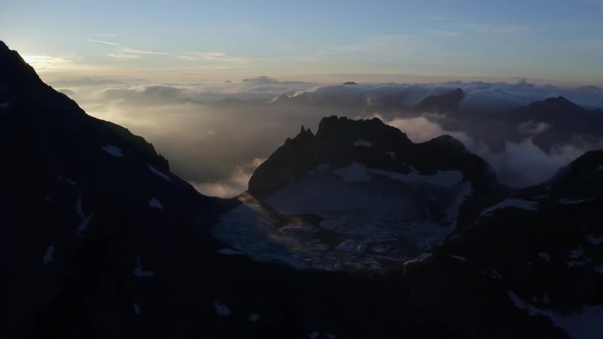The sun is rising over the mountain range