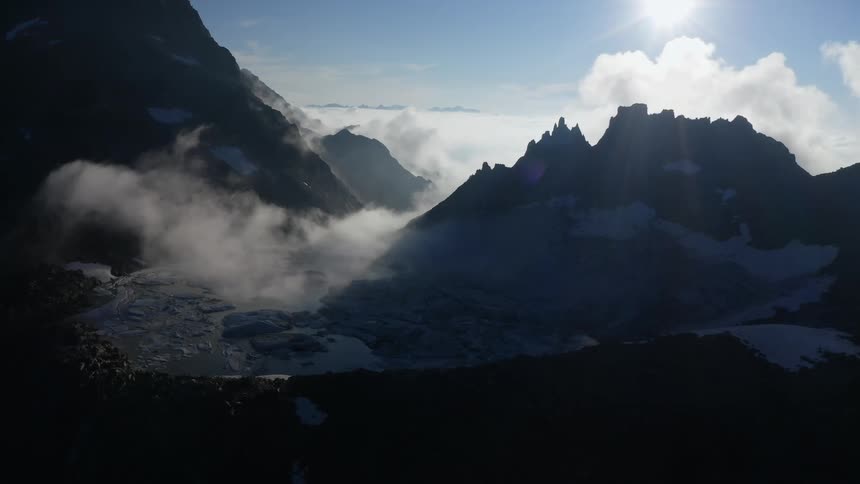 The clouds sit over the mountain range